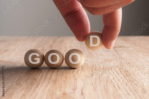 Fotografie, Tablou Hand putting on good word written in wooden cube