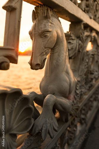 Iron railings of the fence with horses on Annunciation bridge decorated with hippocampus or hippocamp, often called a sea-horse, close up, vertical/
