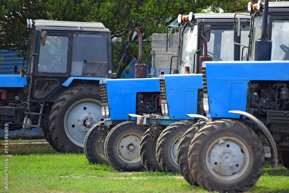 Tractor, standing in a row. Agricultural machinery. Parking of agricultural machinery. Tractor, standing in a row. Agricultural machinery. Parking of agricultural machinery.