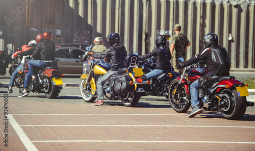 a column of motorcycles ride along the road, a motorcycle view from behind, a motor tour