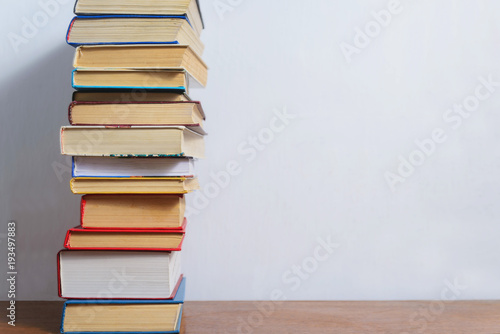 Stack of different books on a woogen table