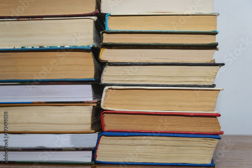 Stack of different books on a woogen table