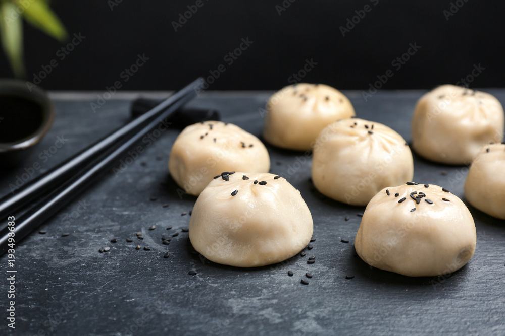 Slate plate with tasty baozi dumplings, closeup Slate plate with tasty baozi dumplings, closeup