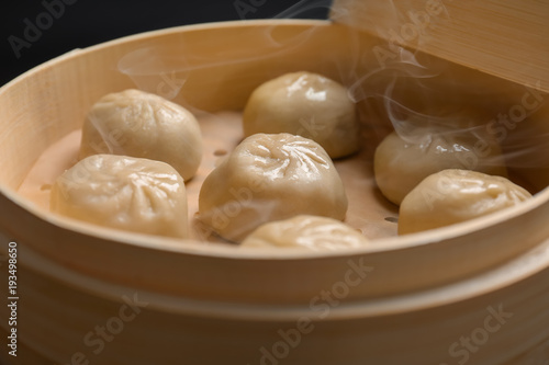 Bamboo steamer with tasty baozi dumplings, closeup
