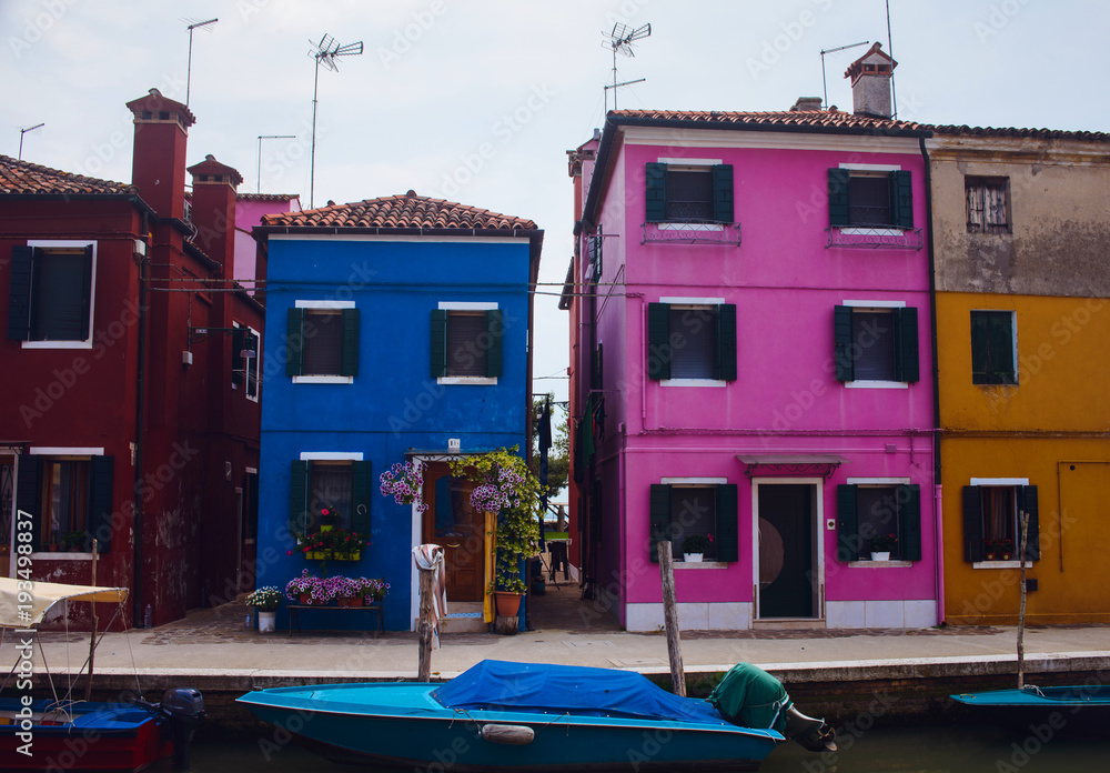 Beautiful Venice landmark, Burano island canal, colorful houses and boats, Italy