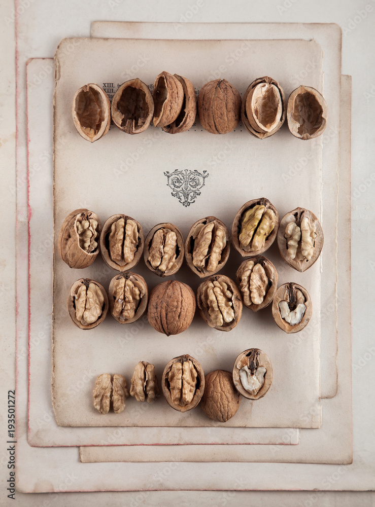 Beautifully presented walnuts on old book pages can be used as background Beautifully presented walnuts on old book pages can be used as background