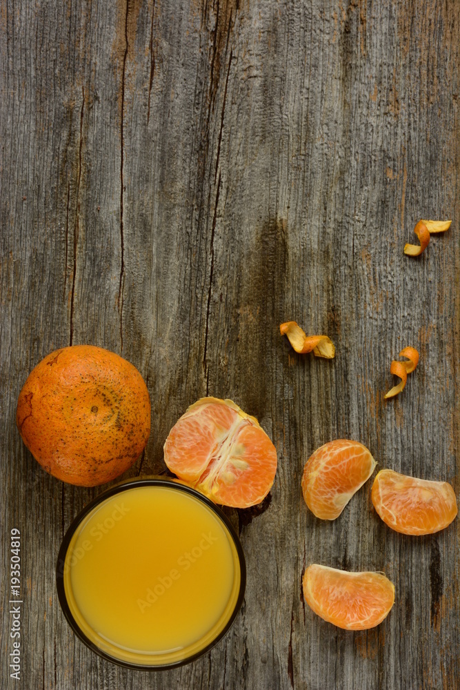 The glass of fresh orange juice with dumbbells The glass of fresh orange juice with dumbbells