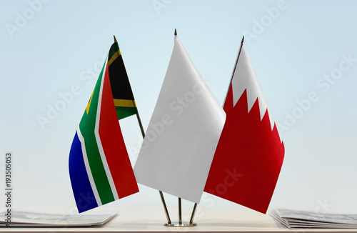 Flags of Republic of South Africa and Bahrain with a white flag in the middle photo