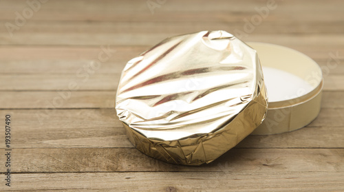 Beautiful Round of Soft Cheese with Gold Foil Wrapper