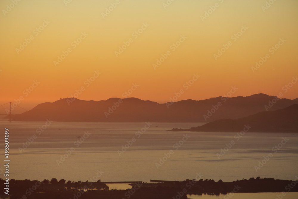 Sunset in the Bay Area San Francisco over bay and with bridge and city Sunset in the Bay Area San Francisco over bay and with bridge and city
