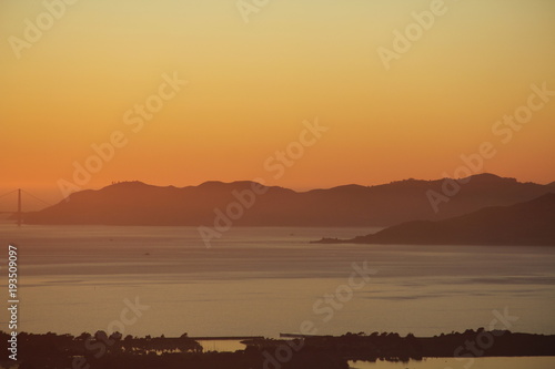 Sunset in the Bay Area San Francisco over bay and with bridge and city