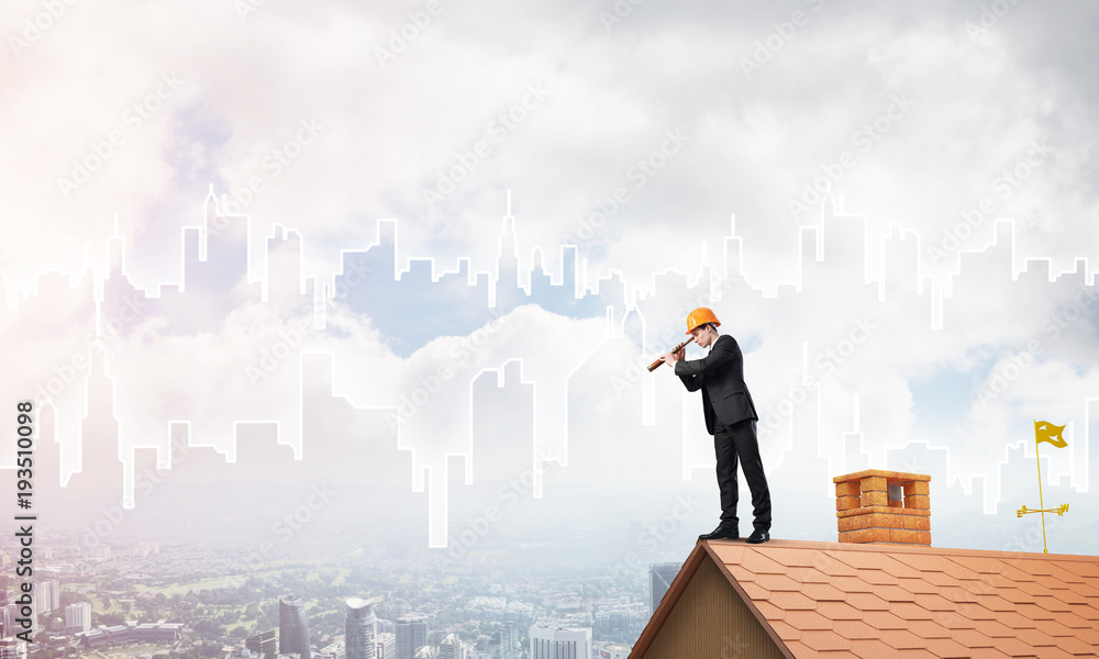 Engineer man standing on roof and looking in spyglass. Mixed media Engineer man standing on roof and looking in spyglass. Mixed media