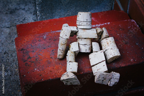 Closeup of Cork Doll on Brick