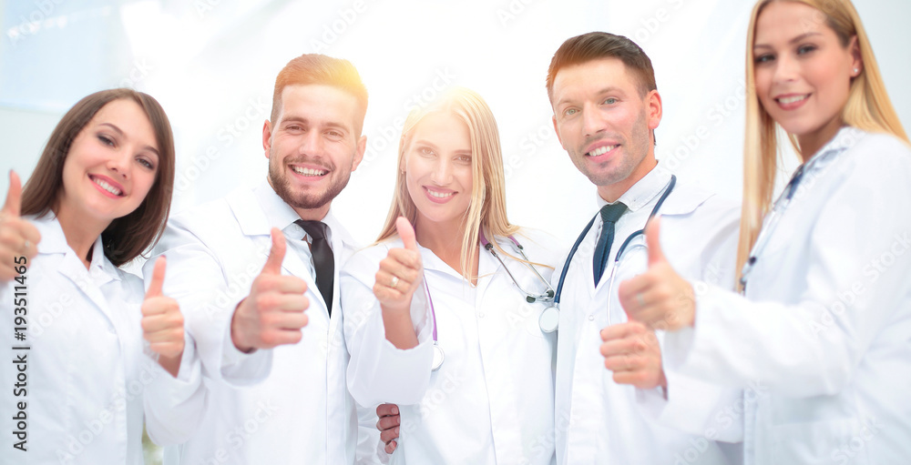 Portrait of a doctor and medical team showing thumb up Portrait of a doctor and medical team showing thumb up