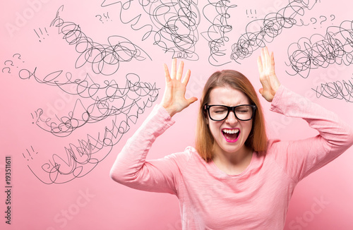 Fotografie Confused young woman feeling stressed on a pink background