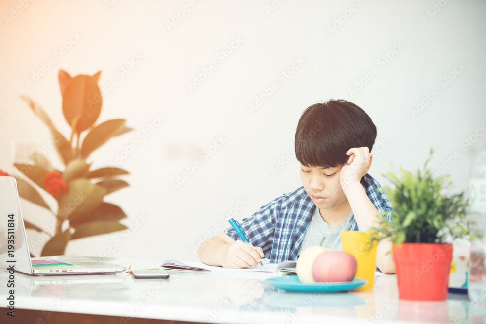 Asian Cute little boy reading book with serious face . Asian Cute little boy reading book with serious face .