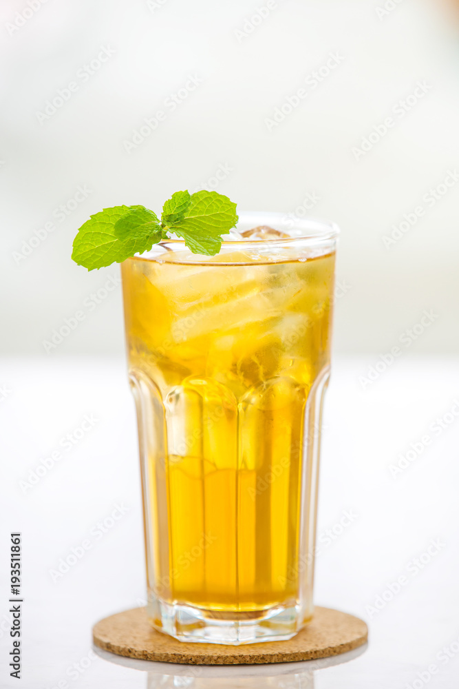 Glasses of iced tea mint on wooden coaster background . Glasses of iced tea mint on wooden coaster background .