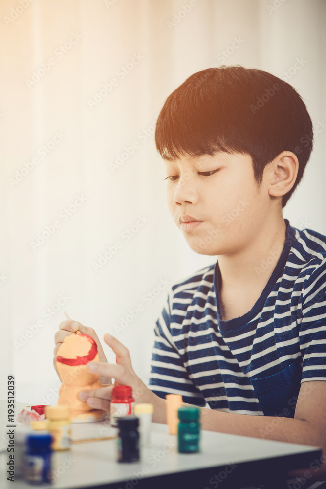 Portrait of a cute little boy messily playing with paints. Portrait of a cute little boy messily playing with paints.