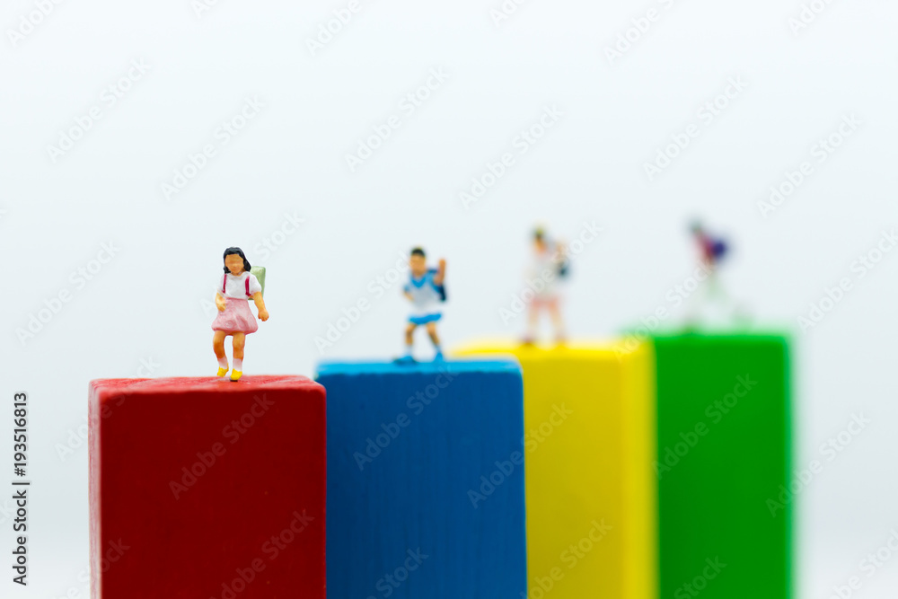 Miniature people: Group childrens stand on wood block color. Image use for education concept. Miniature people: Group childrens stand on wood block color. Image use for education concept.