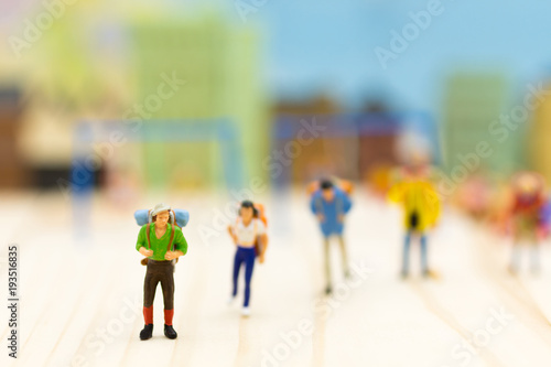 Miniature people: Travelers standing on white background , Image use for travel concept.