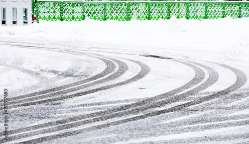 Car tire track on snow in the winter road