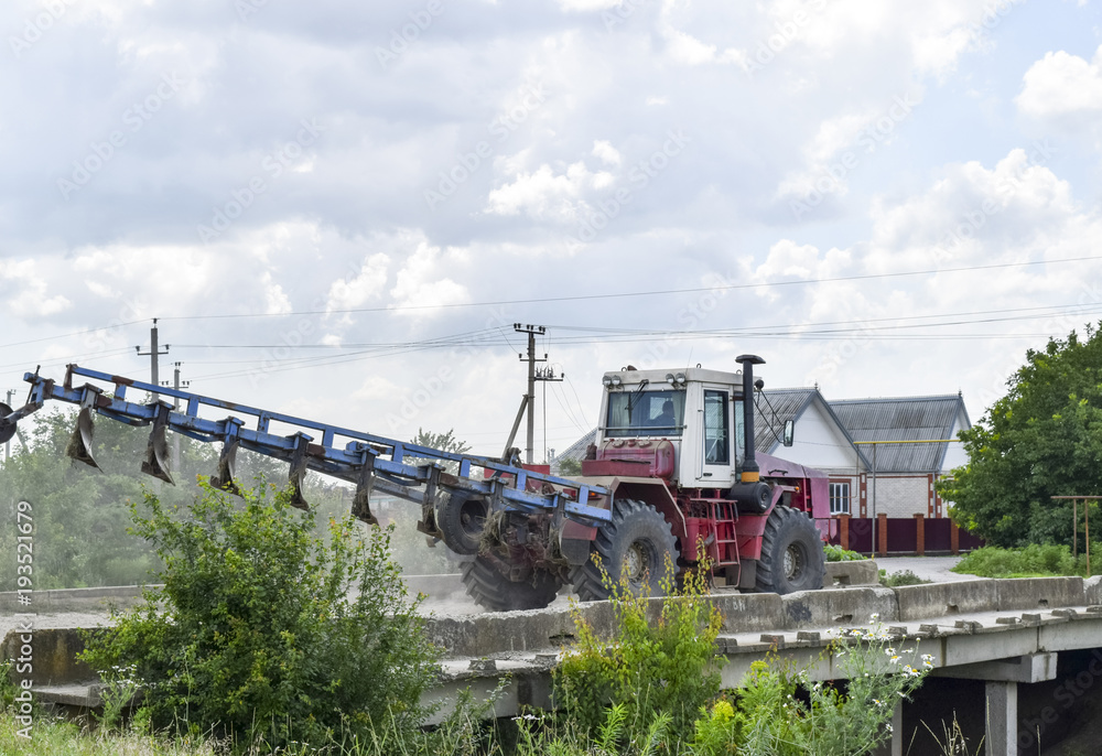 Plow on trailer for tractor. Plow for plowing soil. Trailer Hitch for tractors and combines. Trailers for agricultural machinery.