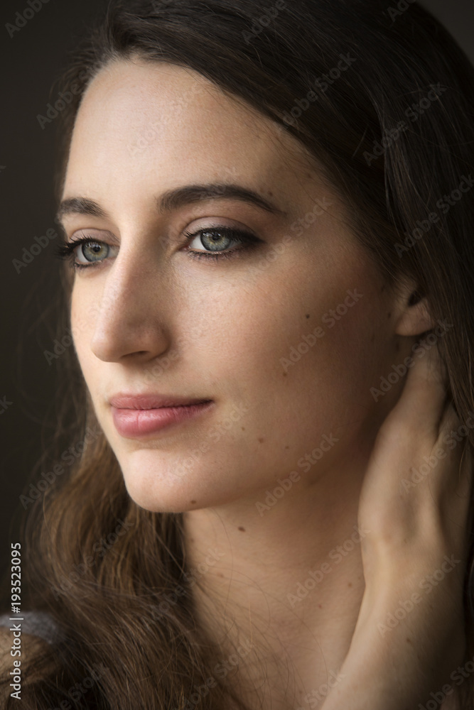Head and shoulders portrait of young woman in windor light. Head and shoulders portrait of young woman in windor light.