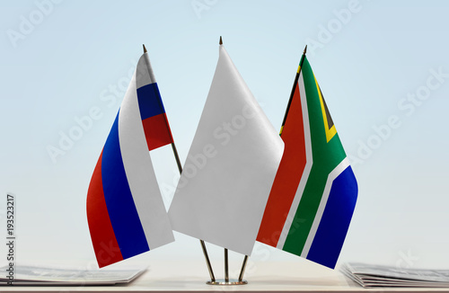 Flags of Russia and Republic of South Africa with a white flag in the middle photo