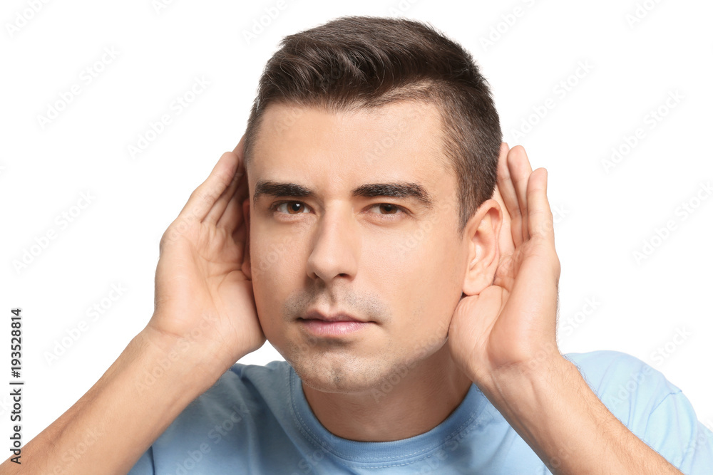 Young man with hearing problem on white background Young man with hearing problem on white background