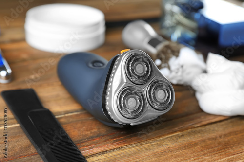 Electric shaver for man on wooden table photo