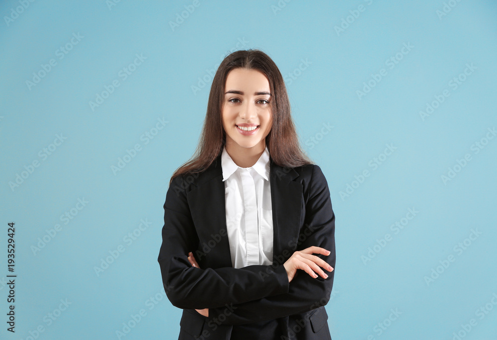 Beautiful young woman in elegant suit on color background Beautiful young woman in elegant suit on color background