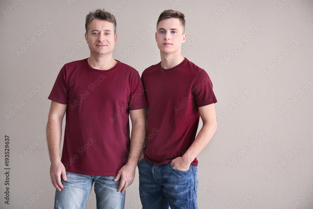 Men in color t-shirt on light background. Mockup for design