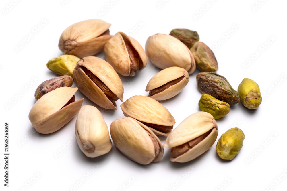 Pile of roasted pistachio nuts (Pistacia vera) isolated on white background Pile of roasted pistachio nuts (Pistacia vera) isolated on white background