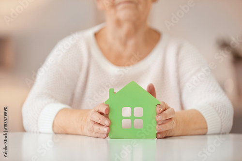 Senior woman with house fig...