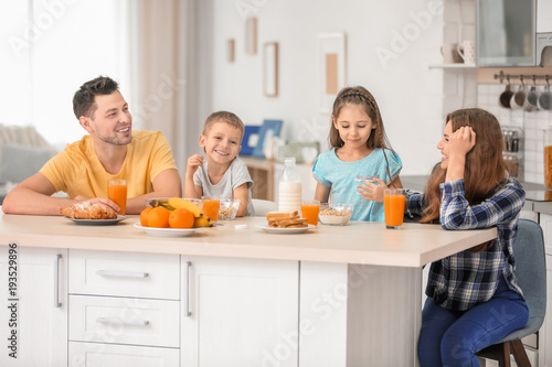 Happy family having breakfa...