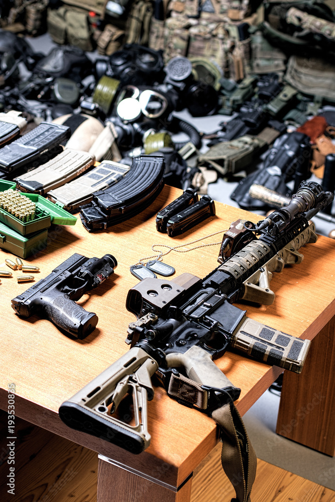 Obraz premium A lot of rifles, guns, grenades, helmets, gas masks, ammunition, vests, devices and other military gear.