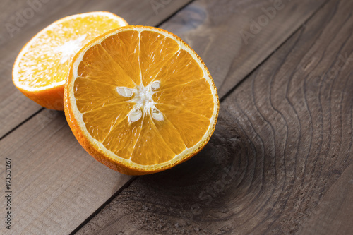 sliced on two halves juicy ripe sweet orange on a table