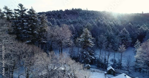 Flying over a farm in New England in the morning snow