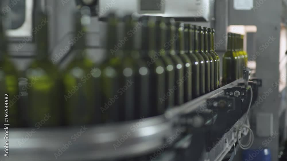Factory of wines, view of bottles on the conveyor in motion.
Factory of wines, view of bottles on the conveyor in motion.