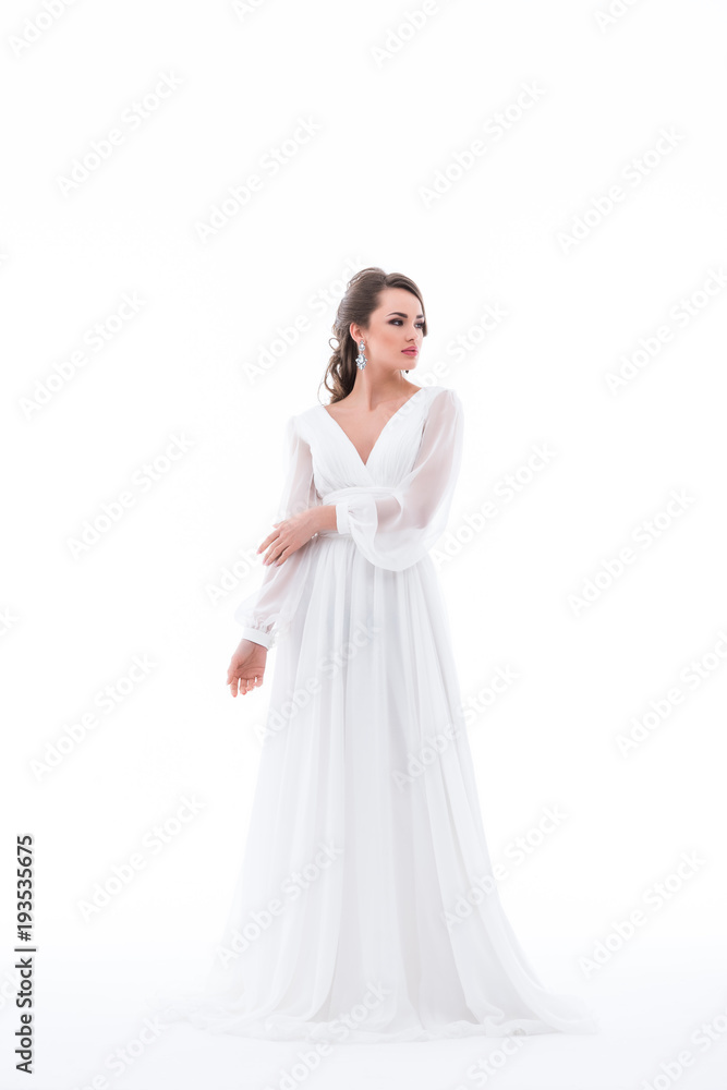 attractive brunette bride posing in traditional wedding dress, isolated on white attractive brunette bride posing in traditional wedding dress, isolated on white