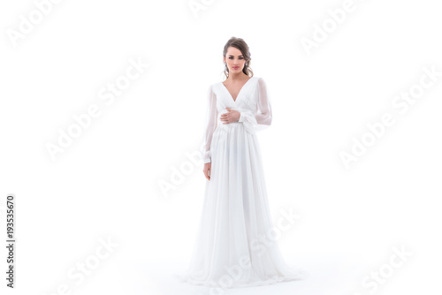 brunette bride posing in traditional wedding dress  isolated on white