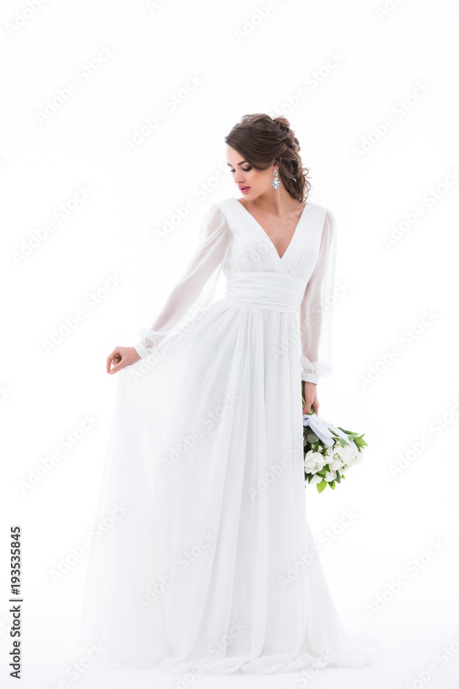 brunette bride posing in elegant white dress with wedding bouquet, isolated on white brunette bride posing in elegant white dress with wedding bouquet, isolated on white