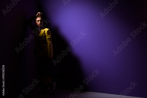 fashionable elegant african american girl posing in dark, on trendy ultra violet background