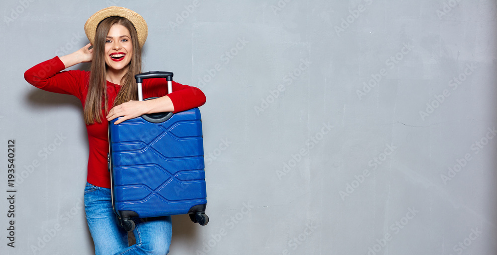 Smiling happy woman with travel suitcase. - obrazy, fototapety, plakaty 