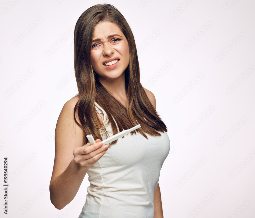 Isolated portrait of diseased woman holding pregnant test.