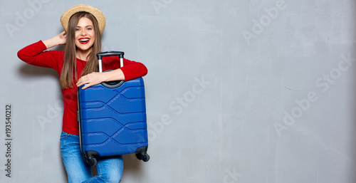 Smiling happy woman with travel suitcase.