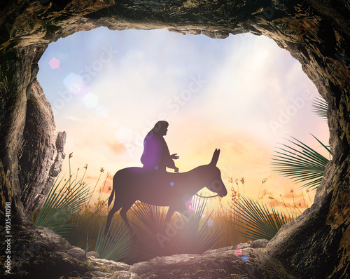 Fotografia Palm Sunday concept: Silhouette Jesus Christ riding donkey with tomb stone on me