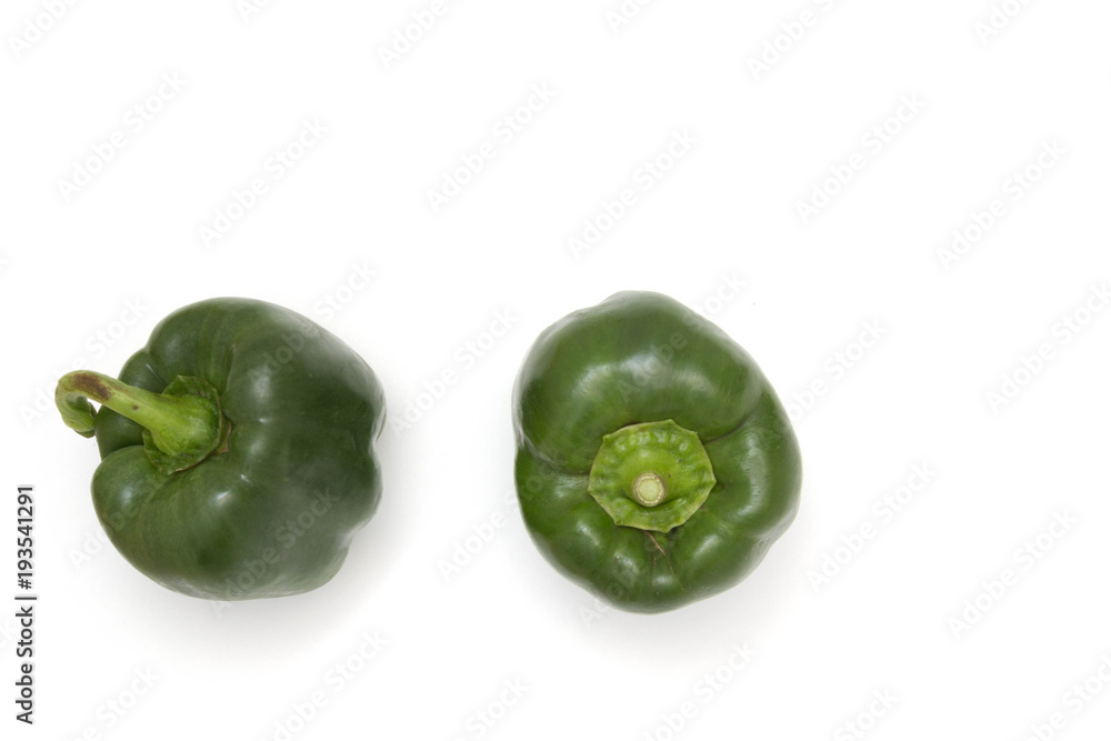 Two green bell peppers against a white background Two green bell peppers against a white background