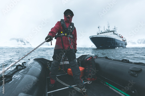 Man steering a Rubber Dinghy - Antarctica photo