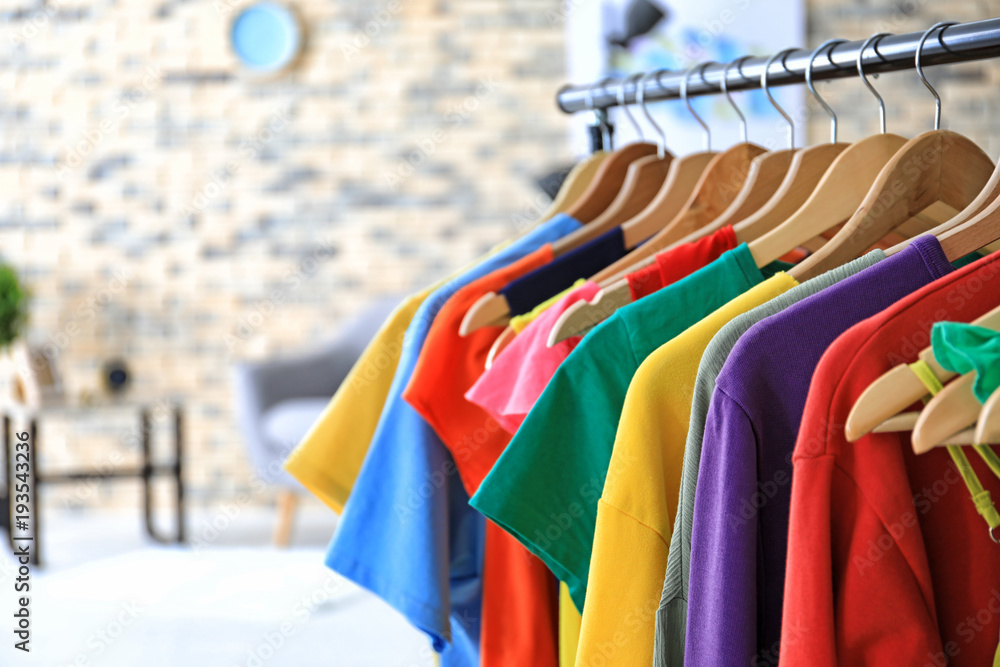 Rack with rainbow clothes indoors Rack with rainbow clothes indoors